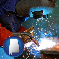 alabama an industrial welder wearing a welding helmet and safety gloves