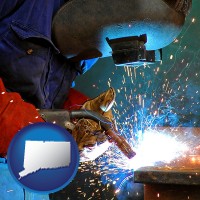 connecticut an industrial welder wearing a welding helmet and safety gloves