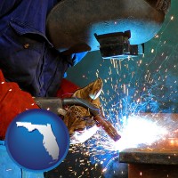 florida an industrial welder wearing a welding helmet and safety gloves
