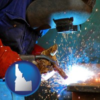 idaho an industrial welder wearing a welding helmet and safety gloves