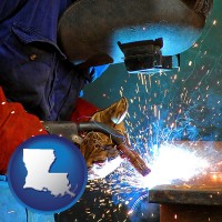 louisiana an industrial welder wearing a welding helmet and safety gloves