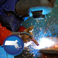 massachusetts an industrial welder wearing a welding helmet and safety gloves