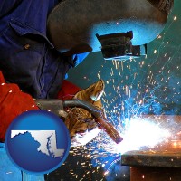 maryland an industrial welder wearing a welding helmet and safety gloves