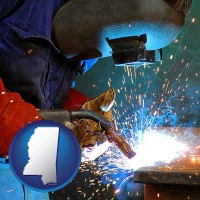 mississippi an industrial welder wearing a welding helmet and safety gloves