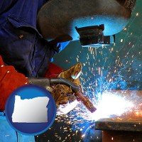 oregon an industrial welder wearing a welding helmet and safety gloves