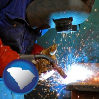 south-carolina an industrial welder wearing a welding helmet and safety gloves