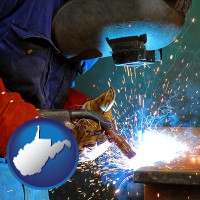 west-virginia an industrial welder wearing a welding helmet and safety gloves