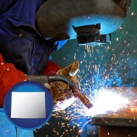 wyoming an industrial welder wearing a welding helmet and safety gloves